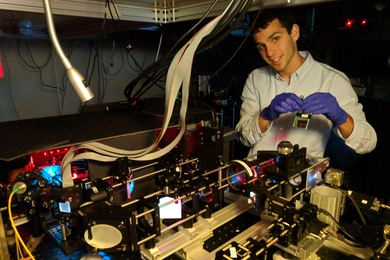 Dylan Cable prepares the Adaptive Upright Microscope, which will ultimately enable deeper imaging of animal brains.