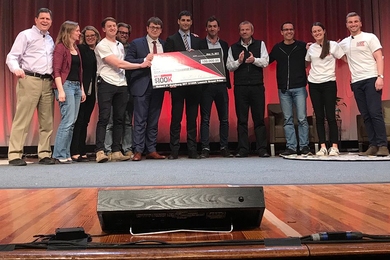 Acoustic wells chief operating officer Charles-Henri Clerget (sixth from left), chief executive officer Sebastien Mannai SM ’14 PhD ’18 (sixth from right), and chief technology officer Louis Creteur (fifth from right) pose with judges and organizers after winning Wednesday’s $100K Entrepreneurship Competition.