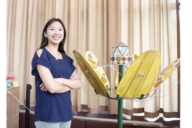 Stephanie Chou ’19 stands with her kinetic art sculpture, "Mess of Gold."