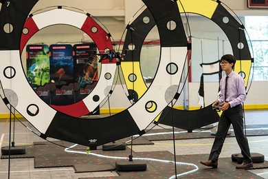 A student from the Beaver Works Summer Institute's Autonomous Air Vehicle Racing class follows an Intel drone as it navigates an obstacle course. 