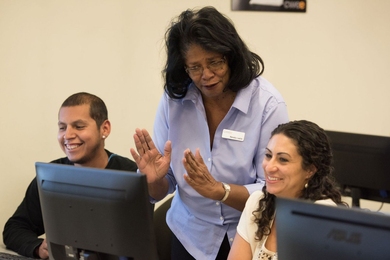 Two career seekers work in the Center for Work Education and Employment’s (CWEE) computer lab with a digital literacy instructor. CWEE is one of four organizations to partner with the Work of the Future Initiative to design an evaluation of their program. 