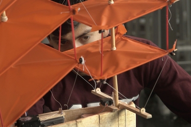 Rodrigo Vasquez examines his team's final project, a plane that also acts a boat on water.