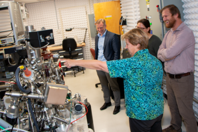 MIT Professor Frances Ross (center) describes the recently installed ultra-high vacuum scanning tunneling microscope to (background, from left) Geoffrey Beach, Jennifer Meanwell, and William Gilstrap.