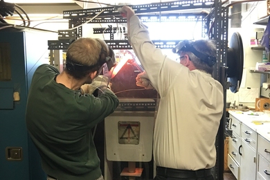 Max Collinet PhD ’19 and Professor Tim Grove work together to extract an experimental sample from a one-of-a-kind rock-melting machine at MIT that reveals clues about planetesimals and the formation of the rocky planets like Earth and Mars. 