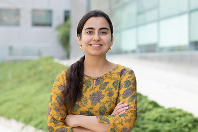 Photo of Gurrein Madan posing with arms crossed outside of an MIT research building