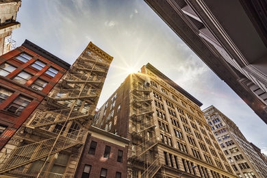 Photo of buildings taken at ground level, looking skyward
