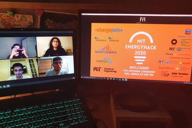 A photo of four people in a Zoom room on a laptop (left) and an orange MIT EnergyHack logo on monitor (right)