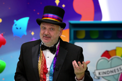 Photo of David Wallace dressed in a top hat, presenting during webcast
