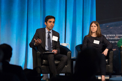 Dharik Mallapragada speaking and gesturing while seated on a panel
