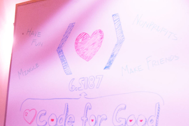 A hand-drawn sign that says "Code for Good" with a heart symbol in between bracket symbols