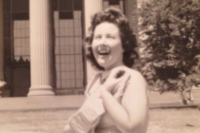 Sepia-colored photo of Ruth Anderson as a young woman, sitting on Killian Court