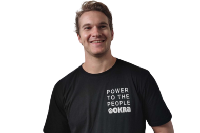Portrait photo of Matthew Johnson in a black “Okra” T-shirt