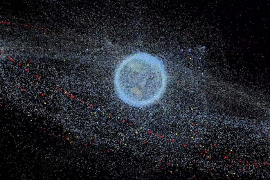 Image of Earth surrounded by millions of dots representing orbiting particles of space debris