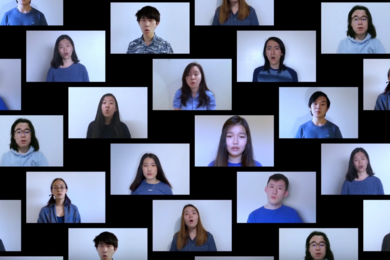 Music video screenshot showing about 20 rectangular boxes on a black background featuring MIT Syncopasian members singing