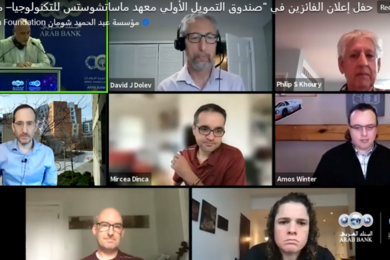 Screenshot of eight people in a Zoom session with Arabic writing overlaid