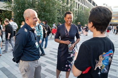 Photo of Chancellor Melissa Nobles (center) smiling and greeting MIT community members.
