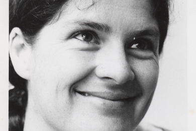 A black-and-white headshot of a smiling Mary Rowe