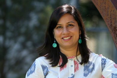 Portrait photo of Sana Aiyar standing under a tree