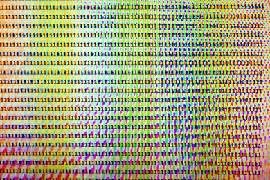 Graphic of rows and columns of the numeral 1 over a varicolored background, abstractly representing information in entropy