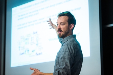 Photo of Professor Zachary Hartwig lecturing in front of a screen