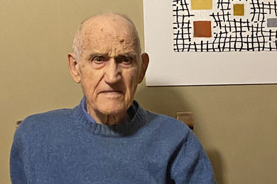 Headshot of Robert Balluffi next to a line-drawing artwork on the wall behind him
