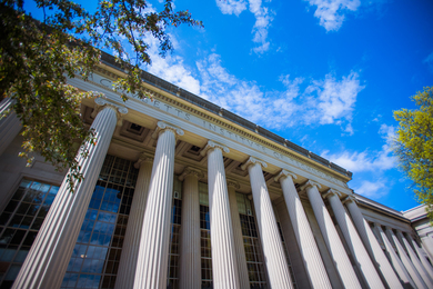 MIT columns and blue skies, as seen from below in MIT’s Killian Court.