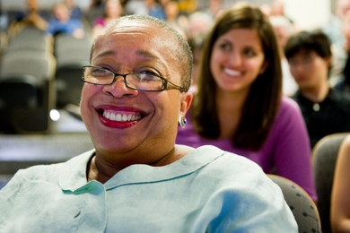 Blanche Staton seated in an audience and smiling broadly