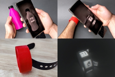 Four photos in a grid. Upper left: A hand holds a bottle and another hand holds a smartphone in front of it, with the screen revealing a black and white square that is an invisible QR code. Upper right: The same phone sees the same QR code in a wristband worn on an arm being scanned by the phone. Lower left: The wristband is shown alone. Lower right: The same wristband reveals several black and white QR codes.
