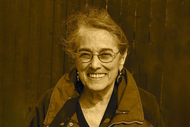 Evelyn Fox Keller smiles and wears a sporty outdoors jacket.