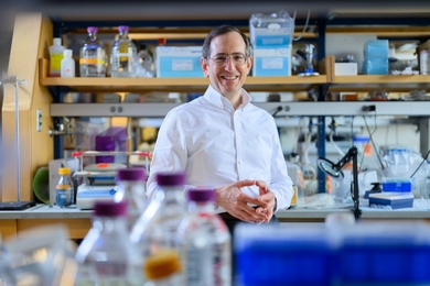 Ernest Fraenkel poses for a photo in a wet lab