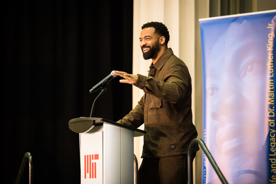 Spencer Paysinger speaks at a podium