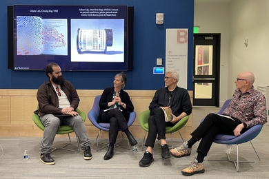 Four people sit in a line in front of a classroom