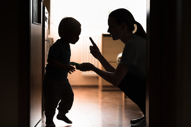 Silhouette of parent scolding a toddler