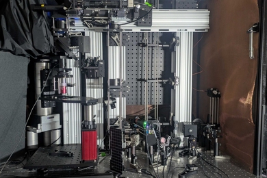 A microscope system comprising a complicated assemblage of optical, electronic, and other equipment atop a metal table