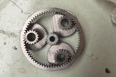 Gearset with a central gear that drives three adjacent gears that propel a surrounding ring