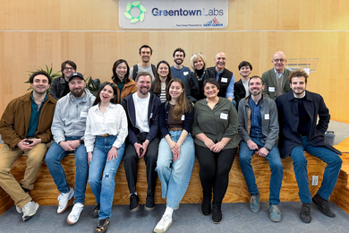 18 people seated and standing together at Greentown Labs