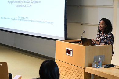 Oleta Johnson speaks from behind an MIT-labled lectern indoors